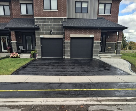 The same new faded driveway after sealing